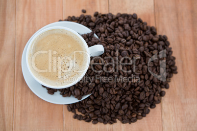 Cup of coffee with roasted coffee beans