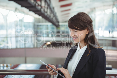 Businesswoman using digital tablet on platform