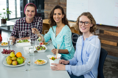 Smiling business executives having meal in office