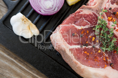 Sirloin chop and ingredients on grill tray