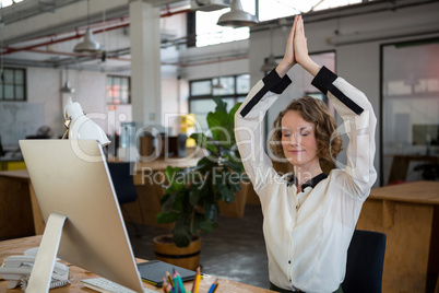 Female graphic designer performing yoga