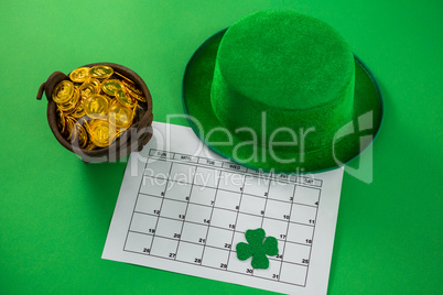 St. Patricks Day leprechaun hat with shamrock, calendar and pot with chocolate gold coins