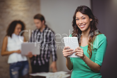 Female executive holding digital tablet