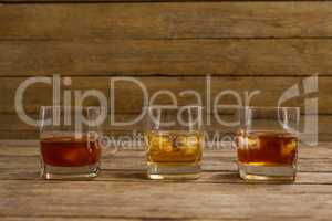 Three glasses of whiskey with ice cube