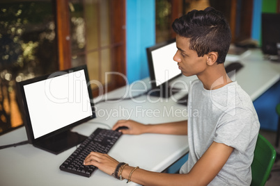 Schoolboy studying in computer classroom