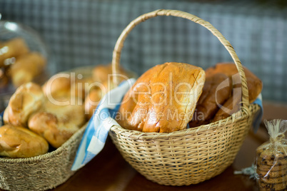 Close-up of fresh bread in a wicker basket on counter