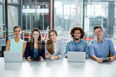 Smiling business team working together in meeting at office