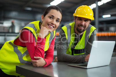 Factory workers using digital tablet