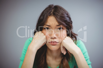 Sad female executive sitting in office