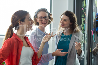 Business executives discussing with each other in office