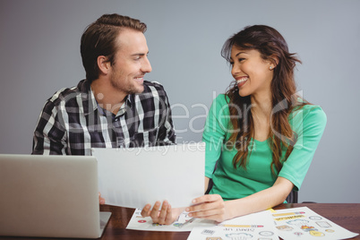 Male and graphic designers working together in conference room