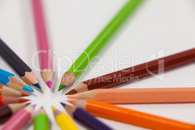 Close-up of colored pencils arranged in a circle