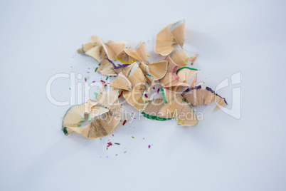 Colored pencils shavings on a white background