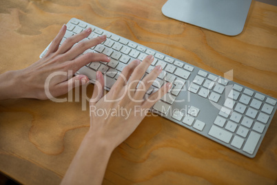 Hand of female graphic designer typing on keyboard