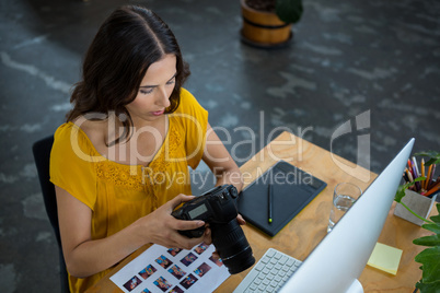 Graphic designer looking at pictures in digital camera