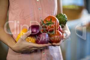 Woman holding vegetables at grocery store