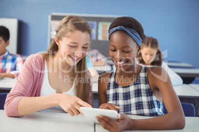 Students using digital tablet in classroom