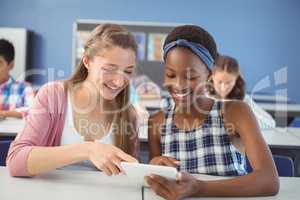 Students using digital tablet in classroom