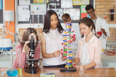 Group of students experimenting molecule model in laboratory