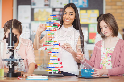 Students experimenting molecule model in laboratory