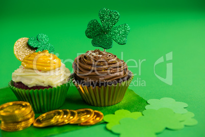 St Patricks Day shamrock on the cupcake with gold coins