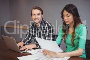 Male and graphic designers working together in conference room