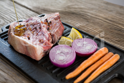 Sirloin chop and ingredients on grill tray