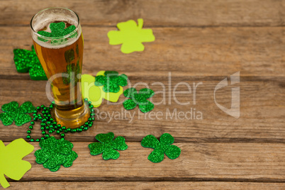 Glass of beer, beads and shamrock for St Patricks Day