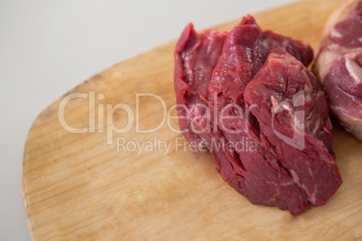 Sirloin chop and beef steak on wooden tray