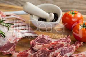 Rib rack, rib chops and ingredients on wooden board