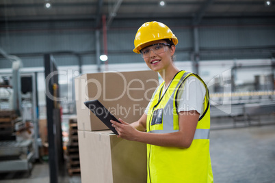 Portrait of smiling female worker using a digital tablet