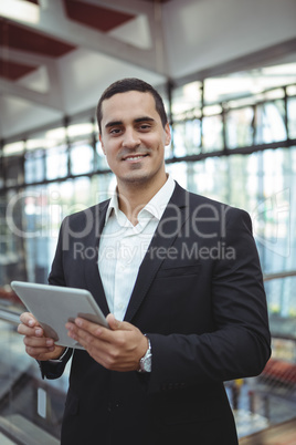 Smiling businessman using digital tablet on platform