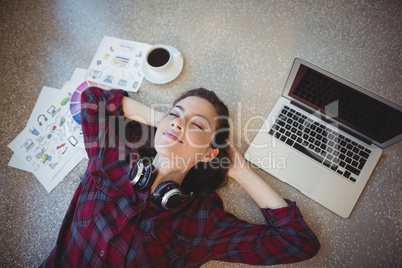 Female graphic designer lying on floor