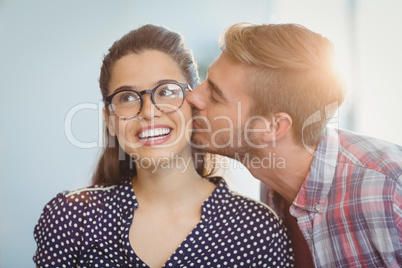 Affectionate man kissing woman