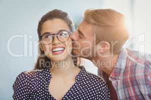 Affectionate man kissing woman