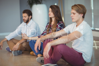 Business executives practicing yoga