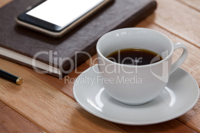 Black coffee with organizer and mobile phone