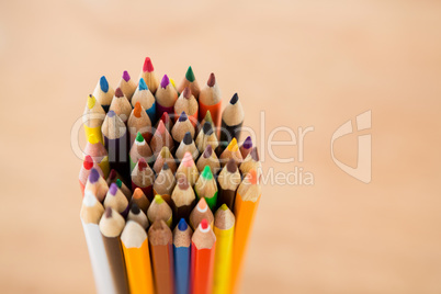 Bunch of colored pencil on beige background
