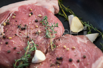 Sirloin chop and herbs in frying pan