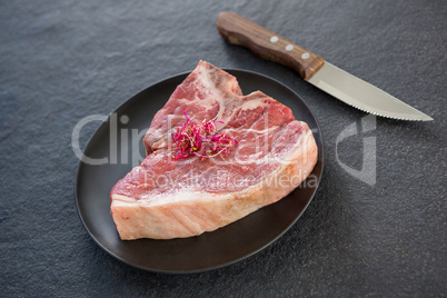 Sirloin chops garnished with shredded cabbage and knife