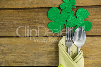 St Patricks Day fork and spoon wrapped in napkin with shamrocks