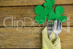 St Patricks Day fork and spoon wrapped in napkin with shamrocks