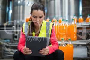 Female factory worker using digital tablet