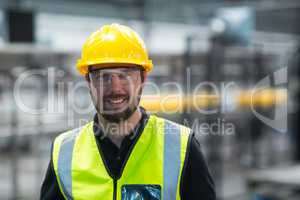 Smiling factory worker standing in factory