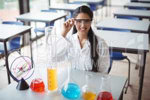 Portrait of schoolgirl sitting in laboratory