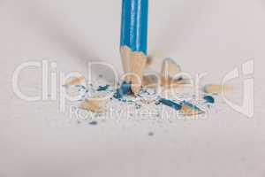 Blue broken colored pencil on white background