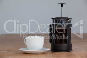 Cafetiere and a cup of black coffee