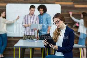 Female business executive using digital tablet in office