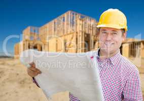 Smiling Contractor Wearing Hardhat Holding Blueprints at Home Co