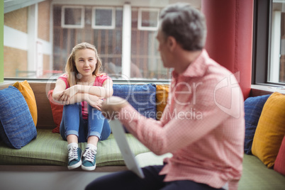 Teacher interacting with student in library